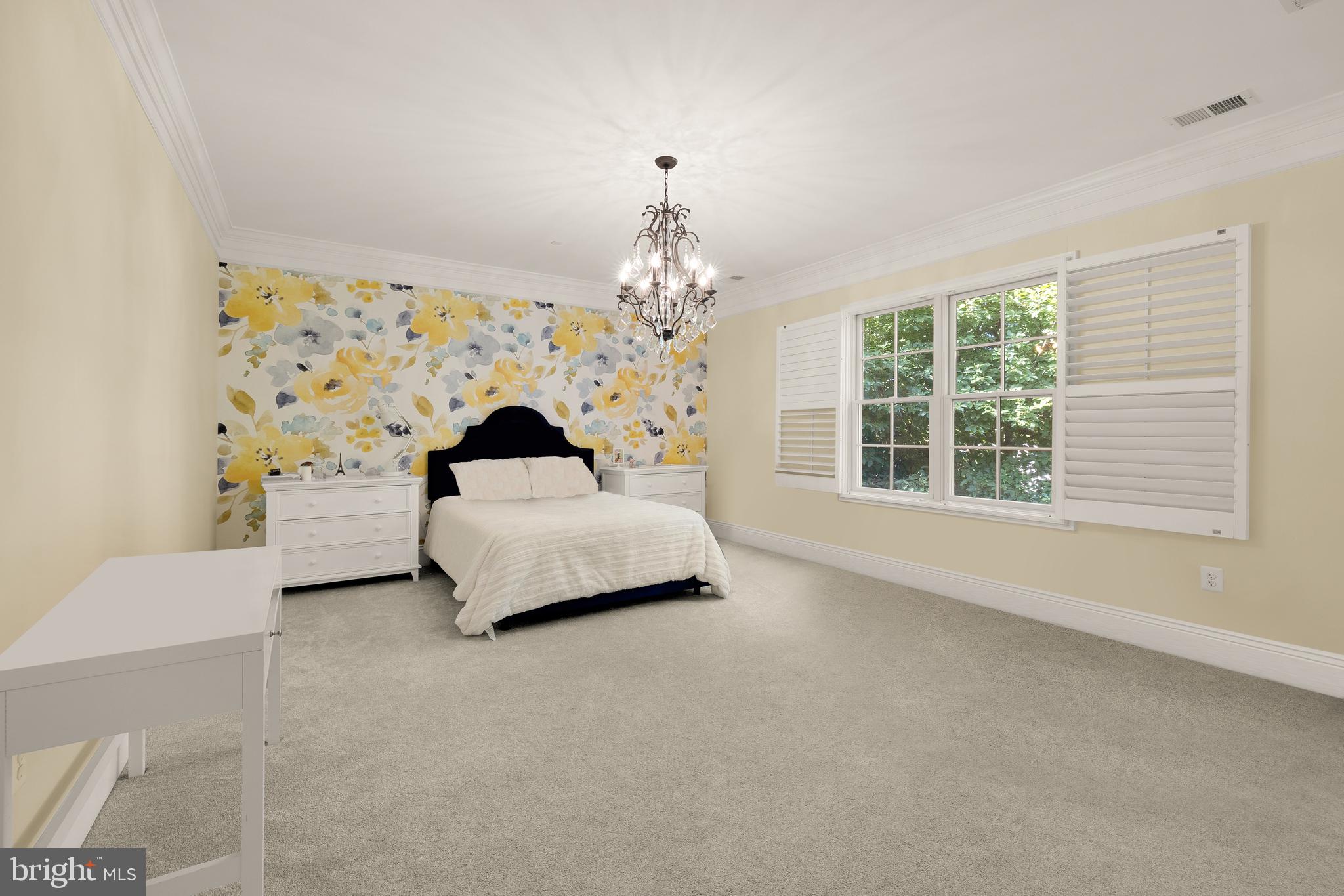 5606 Parkston Road Bethesda, MD 20816 - Photo 35 of 50 a bedroom with a bed and a chandelier