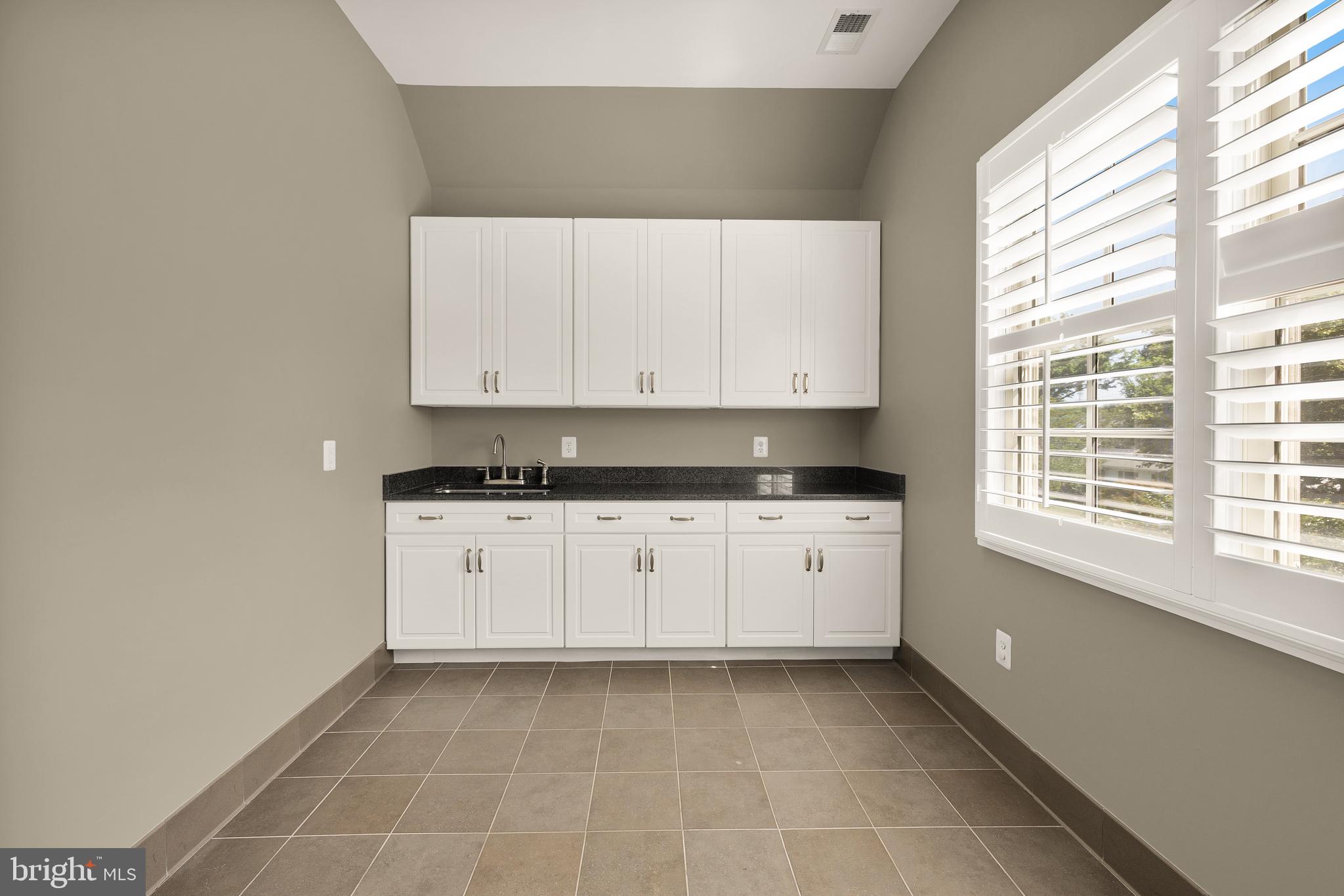 5606 Parkston Road Bethesda, MD 20816 - Photo 42 of 50 a kitchen with a white wooden cabinets and a stove top oven