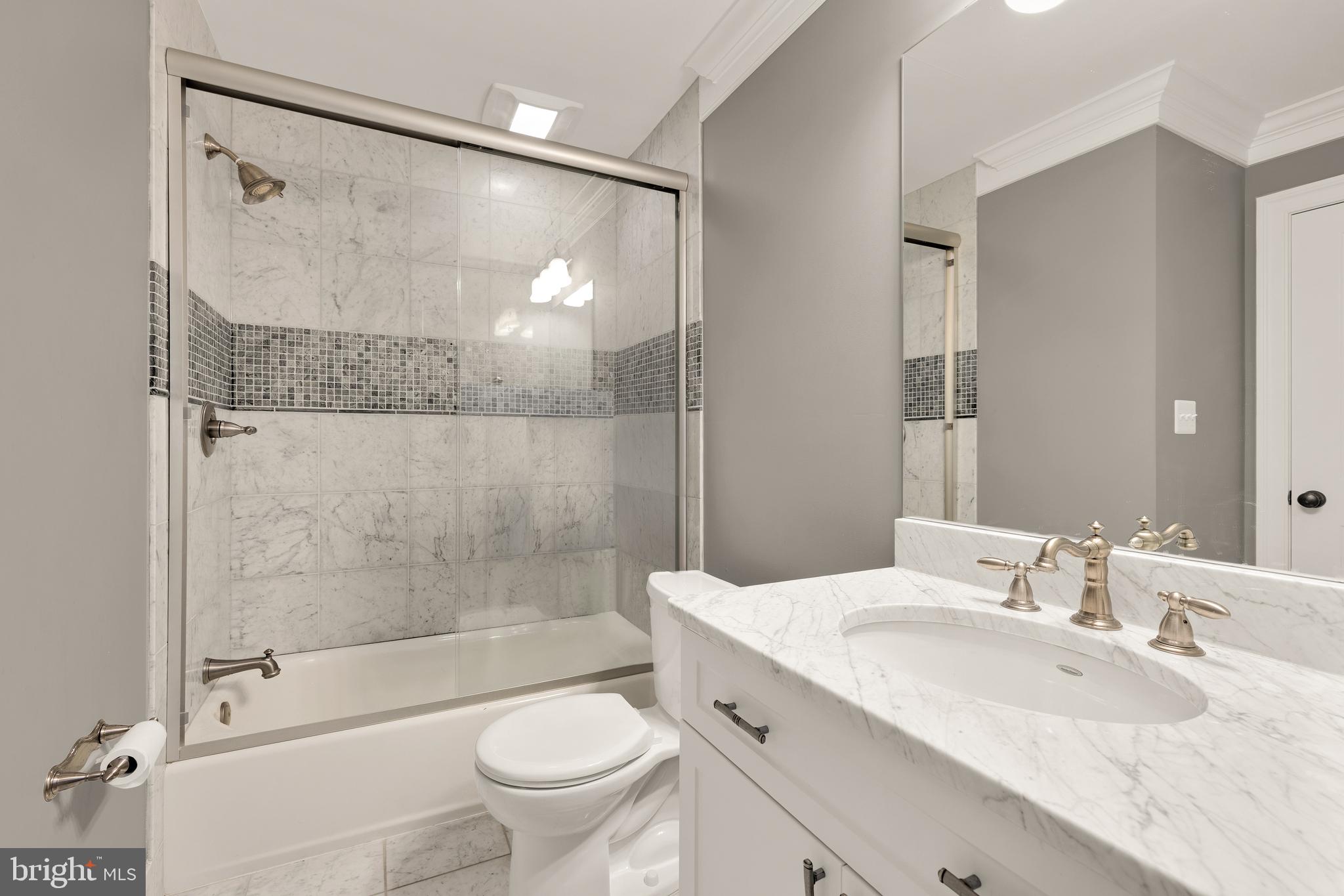 5606 Parkston Road Bethesda, MD 20816 - Photo 47 of 50 a bathroom with a granite countertop sink toilet and shower