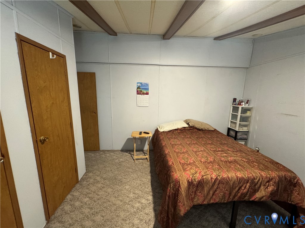 371 Horseshoe Road Jarratt, VA 23867 - Photo 16 of 21 a bedroom with a bed and wooden floor