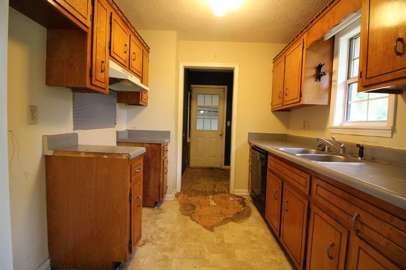 488 Hugh Hunter Road Oak Grove, KY 42262 - Photo 5 of 10 a kitchen with stainless steel appliances granite countertop a sink and cabinets
