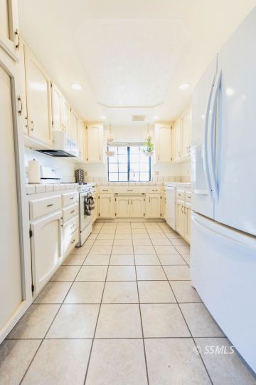 620 East Wilson Avenue Ridgecrest, CA 93555 - Photo 8 of 30 a kitchen with a white cabinets and white appliances