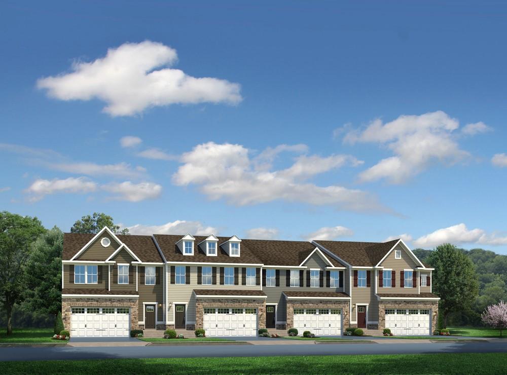 a view of houses with cars parked in front of it