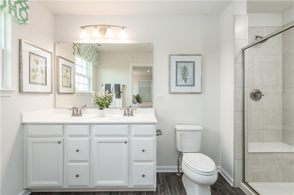 5205 Spruce Road Gibsonia, PA 15044 - Photo 6 of 6 a bathroom with a toilet a sink a mirror a shower a vanity and window