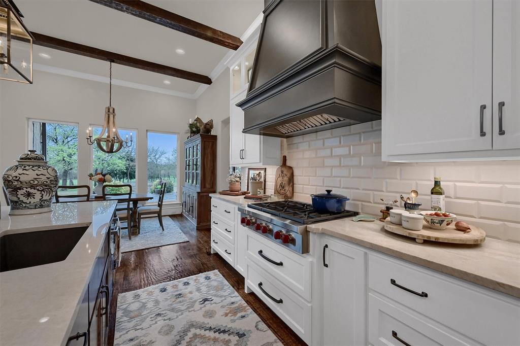 8301 Stephens Ranch Road Pilot Point, TX 76258 - Photo 13 of 40 a kitchen with stainless steel appliances granite countertop a stove a sink and a refrigerator