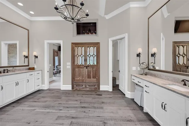 a spacious bathroom with a granite countertop sink mirror and