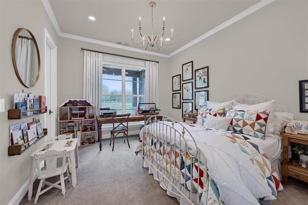 8301 Stephens Ranch Road Pilot Point, TX 76258 - Photo 29 of 40 a bedroom with furniture and a chandelier