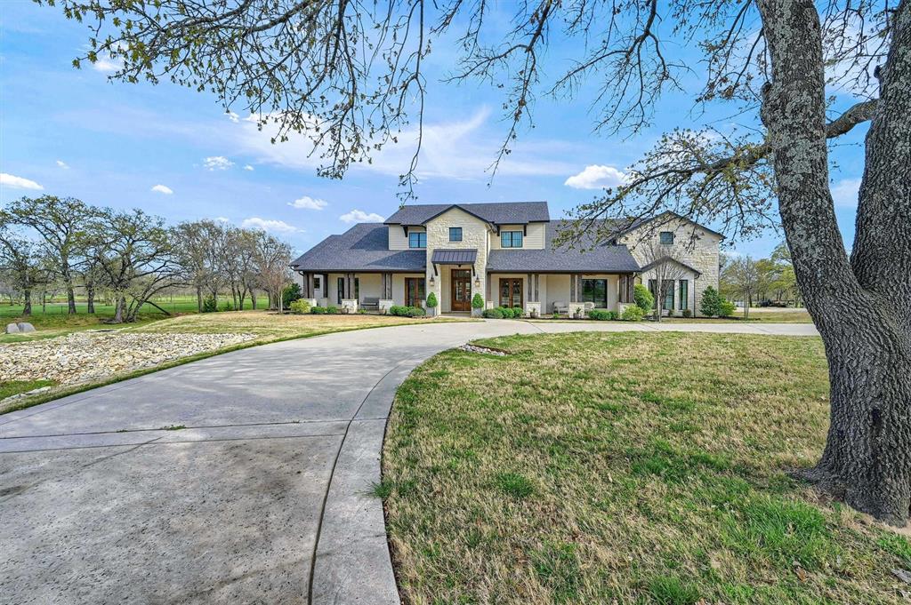 8301 Stephens Ranch Road Pilot Point, TX 76258 - Photo 4 of 40 a front view of a house with a garden