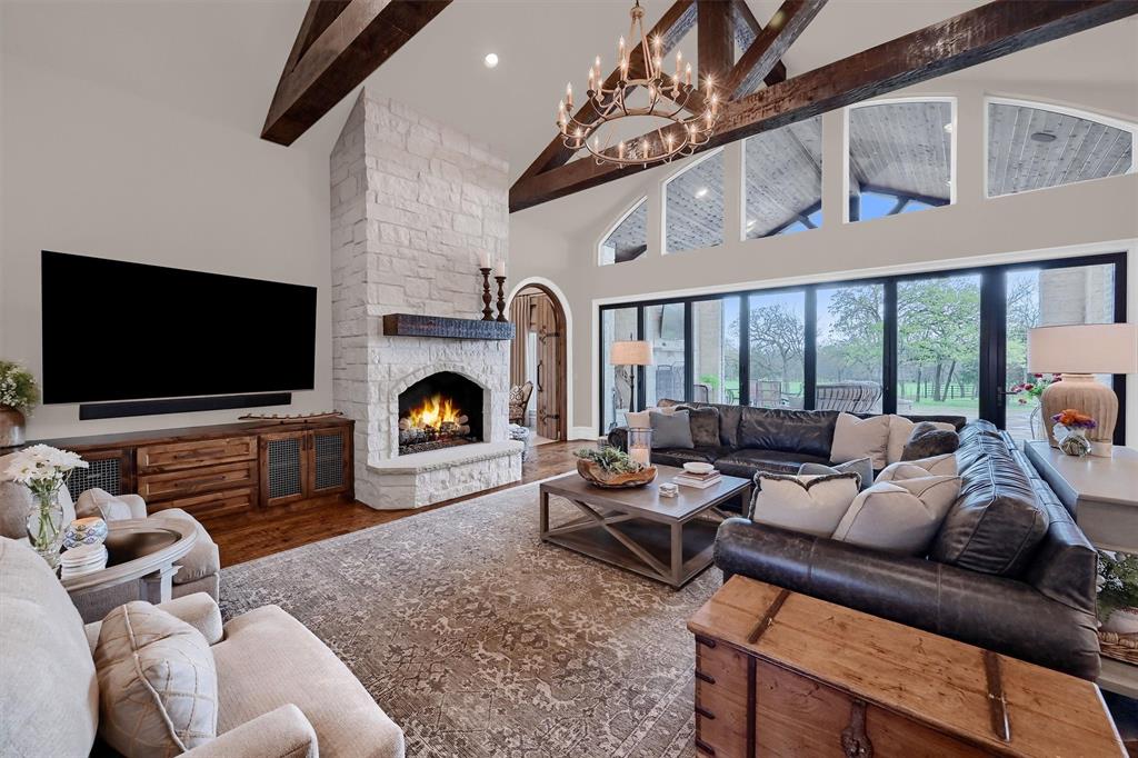 8301 Stephens Ranch Road Pilot Point, TX 76258 - Photo 6 of 40 a living room with furniture a flat screen tv and a fireplace