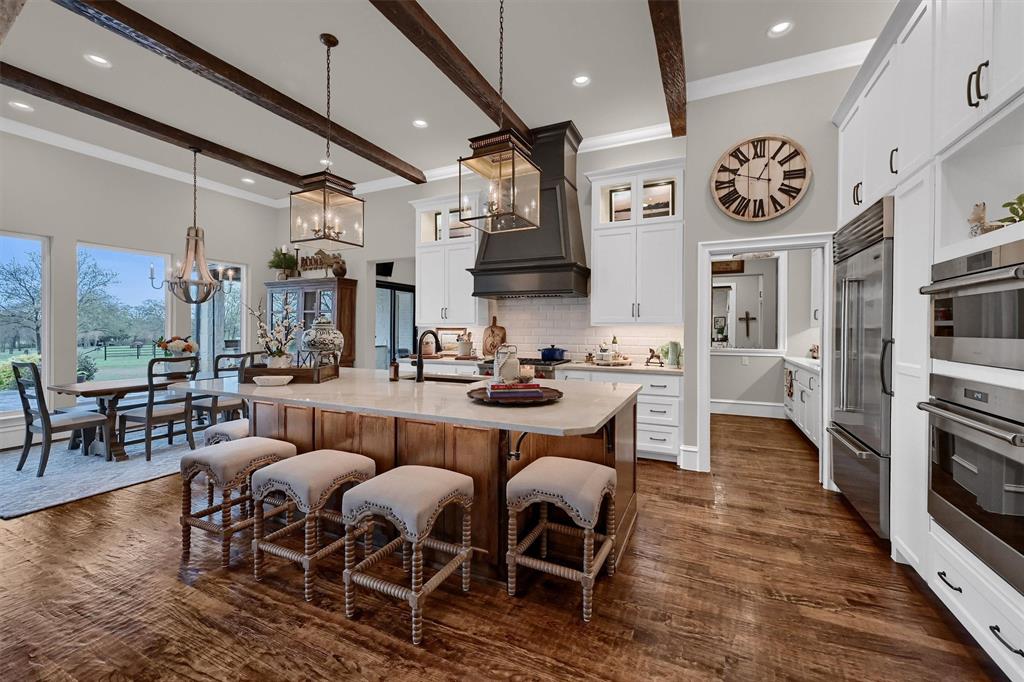 8301 Stephens Ranch Road Pilot Point, TX 76258 - Photo 10 of 40 a dinning room with stainless steel appliances kitchen island granite countertop a couch and a view of living room