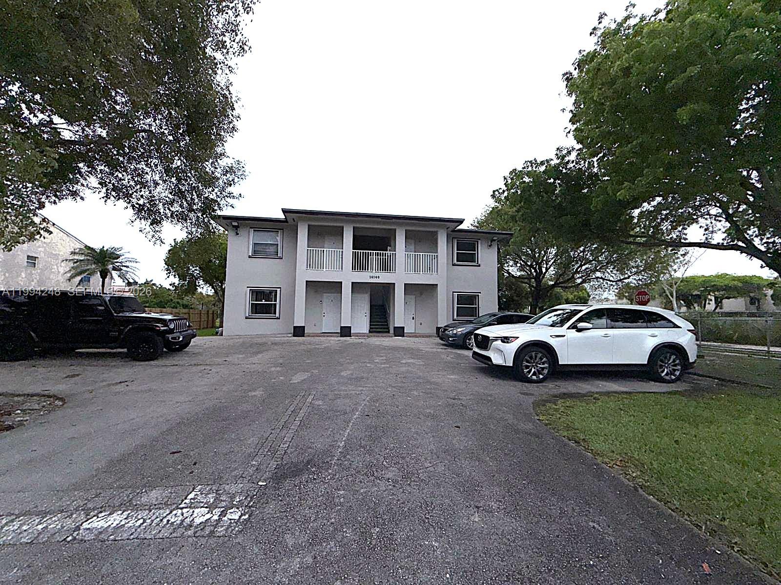 14140 Northeast 2nd Court, Unit 2 Miami, FL 33161 - Photo 1 of 13 a view of street with parked cars