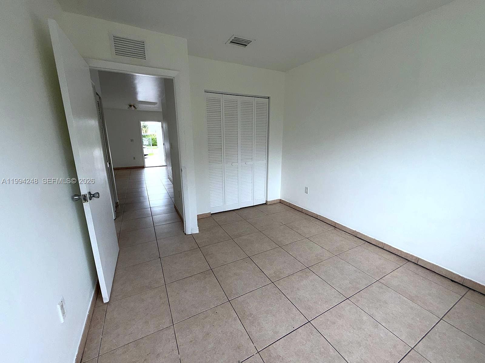 14140 Northeast 2nd Court, Unit 2 Miami, FL 33161 - Photo 12 of 13 an empty room with windows