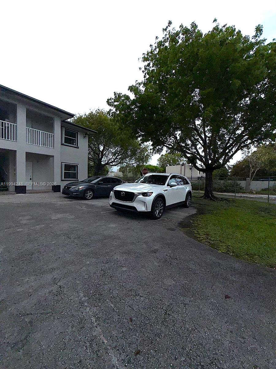 14140 Northeast 2nd Court, Unit 2 Miami, FL 33161 - Photo 13 of 13 a front view of a house with a garden and parking