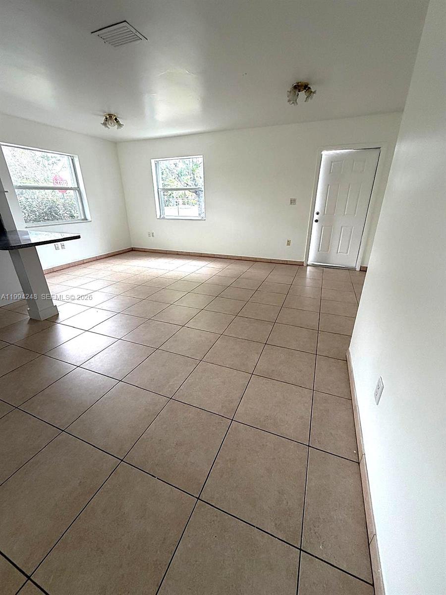14140 Northeast 2nd Court, Unit 2 Miami, FL 33161 - Photo 3 of 13 a view of an empty room and window