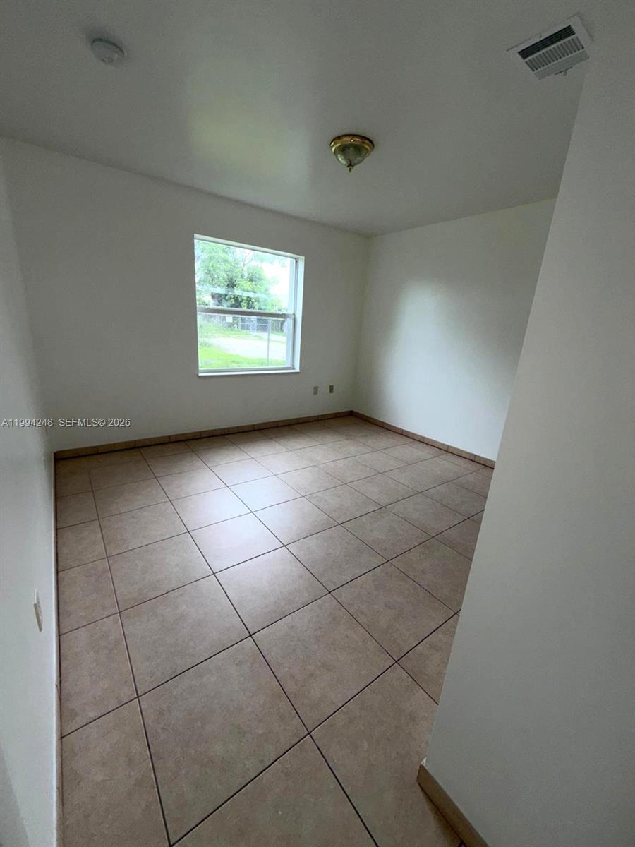 14140 Northeast 2nd Court, Unit 2 Miami, FL 33161 - Photo 7 of 13 a view of an empty room with a window