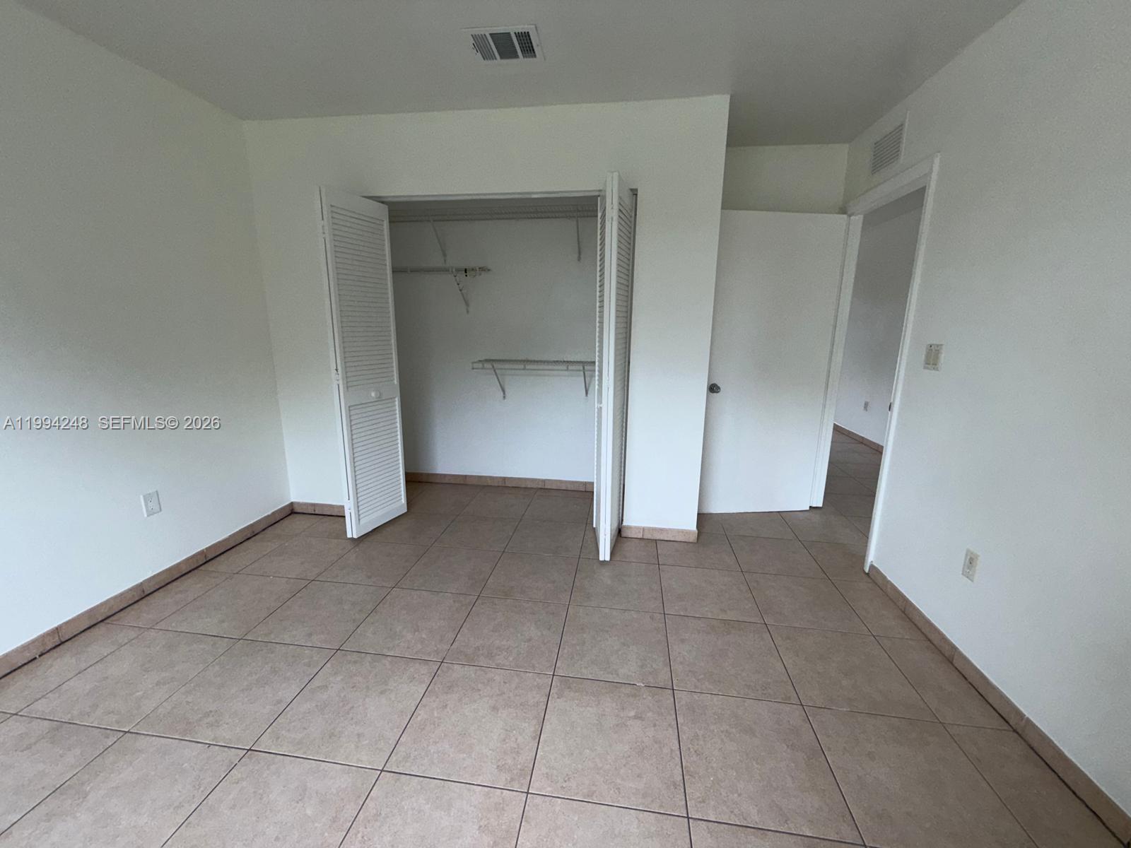 14140 Northeast 2nd Court, Unit 2 Miami, FL 33161 - Photo 8 of 13 an empty room with a bathroom