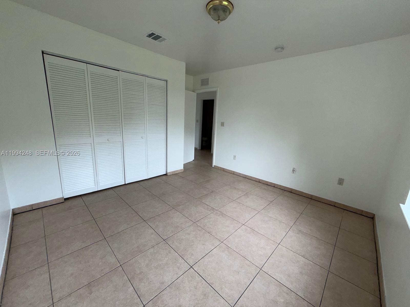 14140 Northeast 2nd Court, Unit 2 Miami, FL 33161 - Photo 9 of 13 a view of an empty room with wooden floor