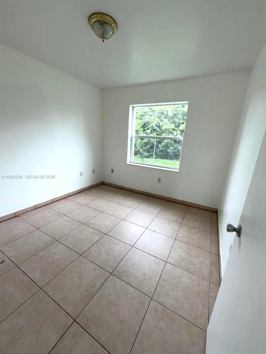 14140 Northeast 2nd Court, Unit 2 Miami, FL 33161 - Photo 10 of 13 en empty room with windows