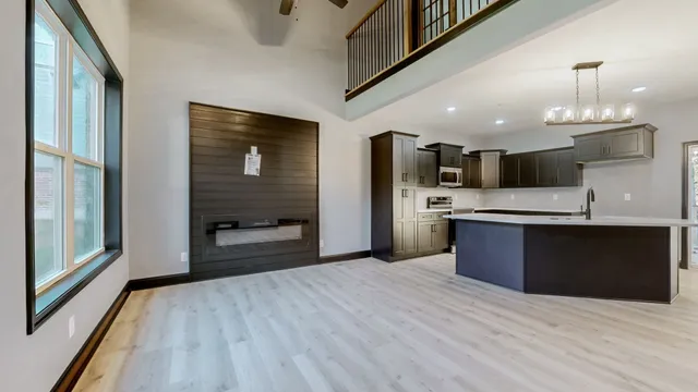 a large kitchen with stainless steel appliances kitchen island granite countertop a large cabinets a sink and a stove