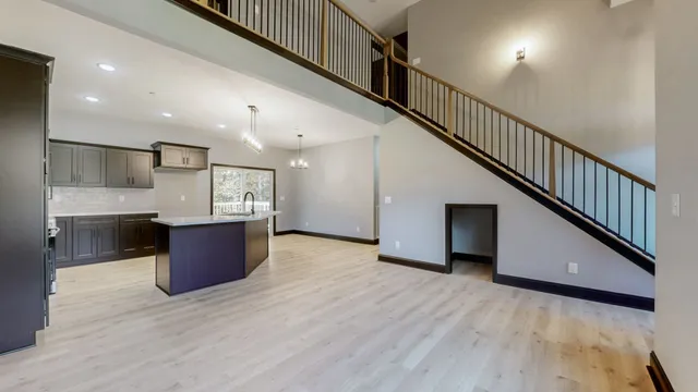 a view of kitchen with stainless steel appliances cabinets and wooden floor