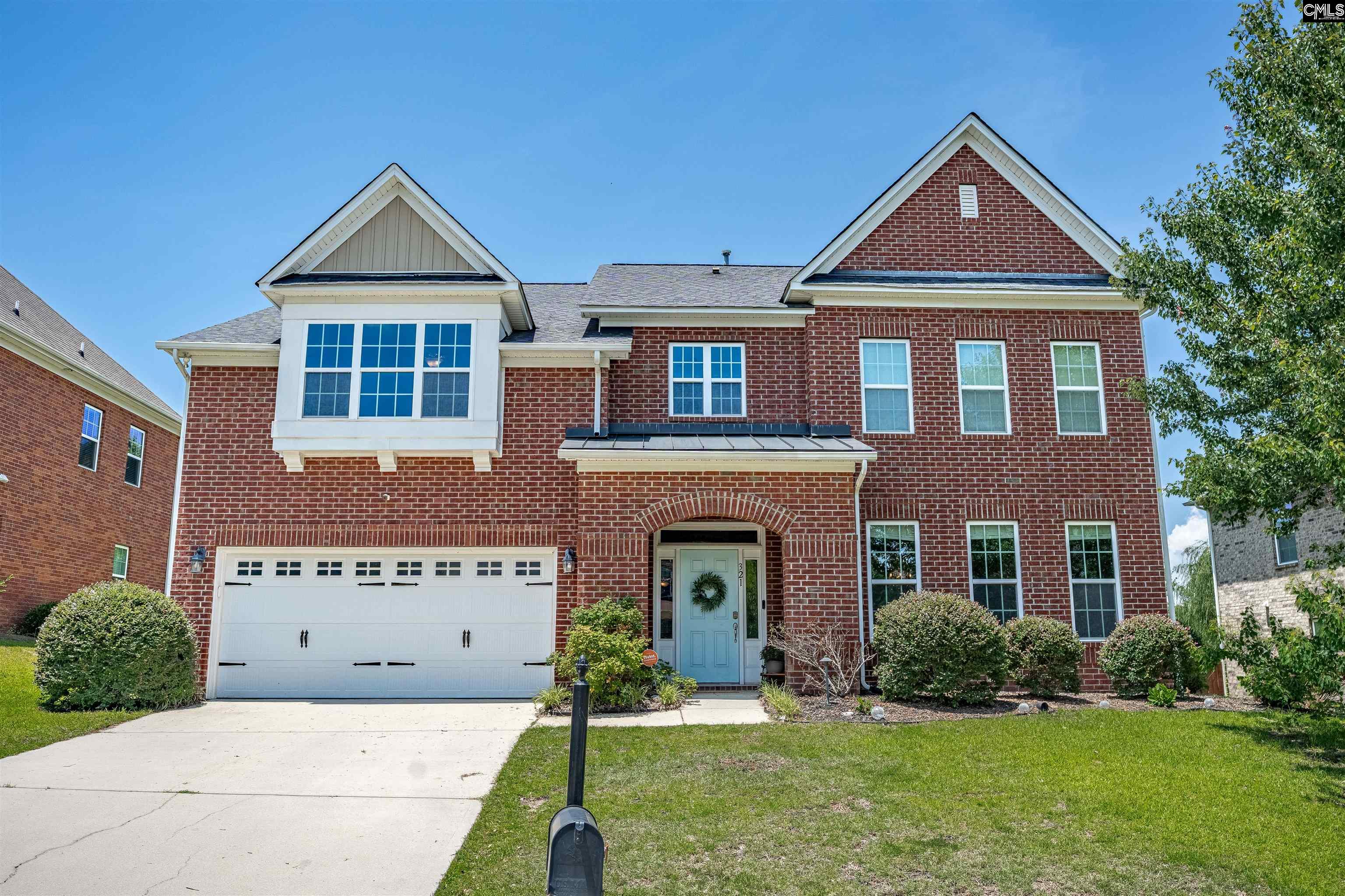 321 Asa Rose Lexington, SC 29072 - Photo 1 of 52 a front view of a house with a yard and garage