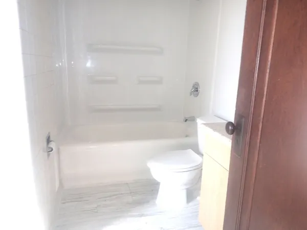a bathroom with a toilet and a shower