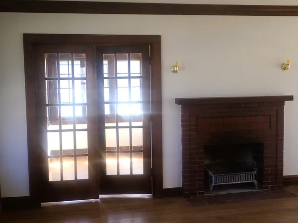 a living room with a fireplace and windows