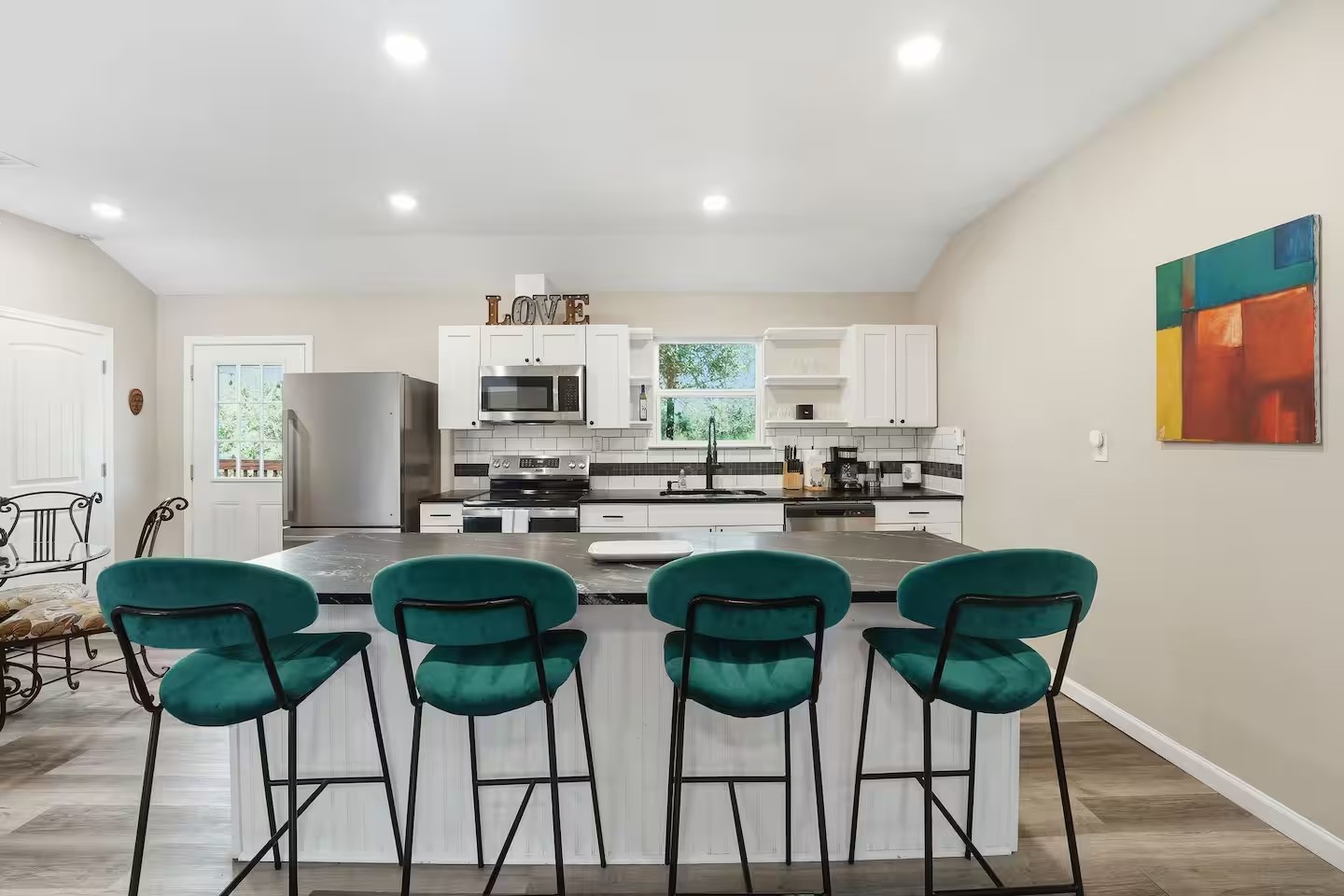 201 Winfield Thicket Road Bastrop, TX 78602 - Photo 15 of 36 a kitchen with stainless steel appliances a dining table chairs and oven