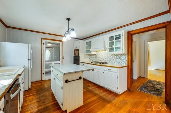 a view of a hallway with bathroom and wooden floor