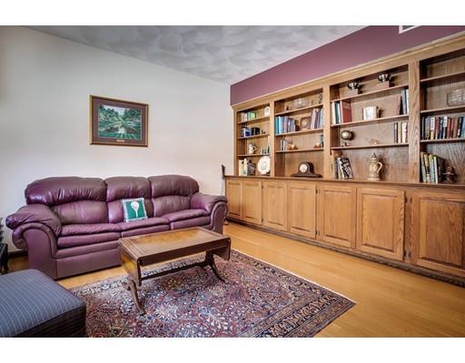 22 Battle Flagg Road Bedford, MA 01730 - Photo 17 of 30 a living room with furniture and a book shelf