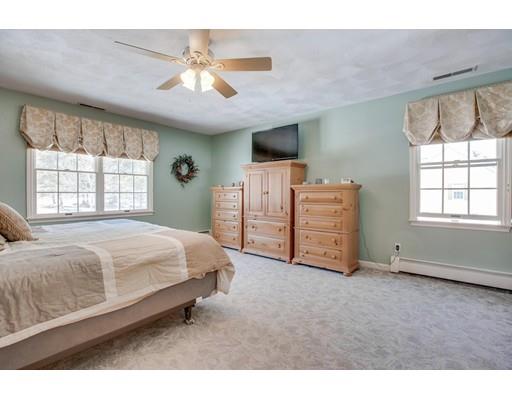 22 Battle Flagg Road Bedford, MA 01730 - Photo 18 of 30 a spacious bedroom with a bed a dresser and a window