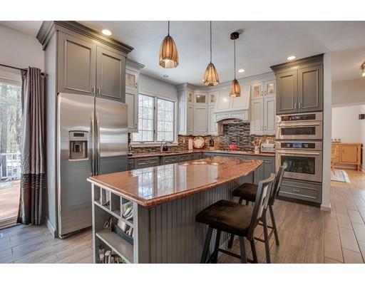 22 Battle Flagg Road Bedford, MA 01730 - Photo 2 of 30 a kitchen with stainless steel appliances granite countertop a sink a stove and refrigerator