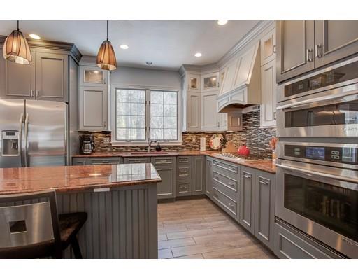 22 Battle Flagg Road Bedford, MA 01730 - Photo 3 of 30 a kitchen with stainless steel appliances granite countertop a stove a sink and a microwave
