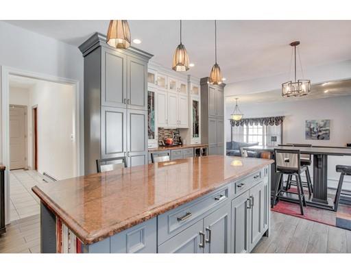 22 Battle Flagg Road Bedford, MA 01730 - Photo 5 of 30 a kitchen with kitchen island granite countertop a sink a counter top space and stainless steel appliances