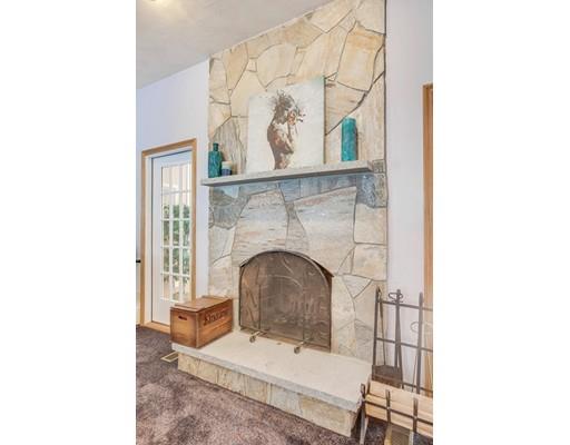 22 Battle Flagg Road Bedford, MA 01730 - Photo 9 of 30 a living room with a fireplace and a painting on the wall