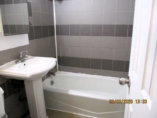 a bathroom with a bathtub and shower