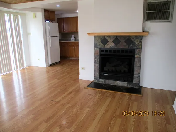 a view of an empty room with a fireplace