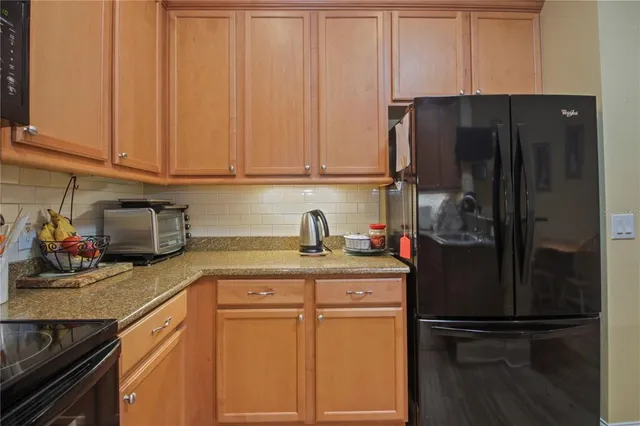 a kitchen with a refrigerator and cabinets