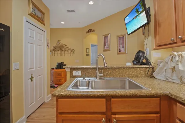 a kitchen with a sink a stove and cabinets