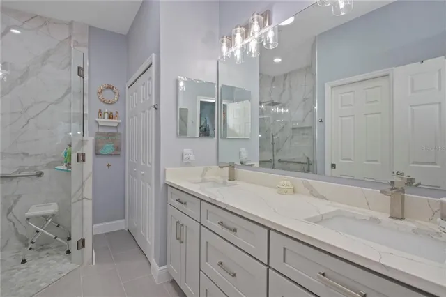 a spacious bathroom with a granite countertop sink a mirror and shower
