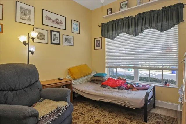 a bedroom with furniture and a window