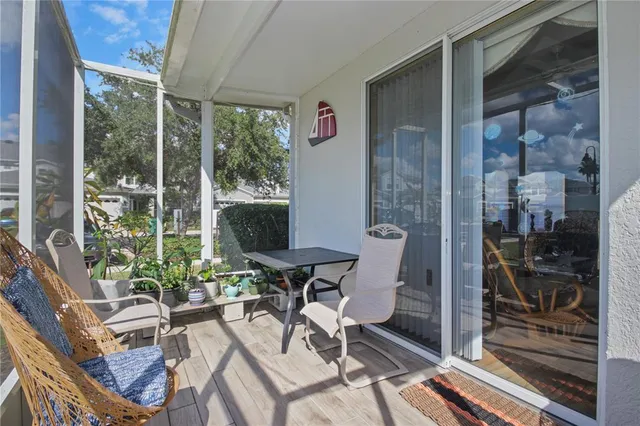 a view of a porch with chairs and backyard