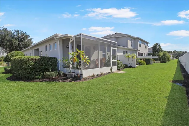 a view of a house with a yard and sitting area
