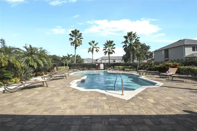 a view of a swimming pool with a lounge chair