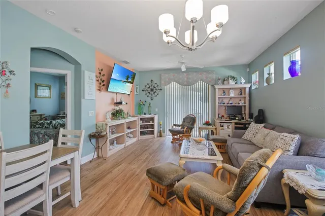 a view of a dining room with furniture wooden floor and chandelier