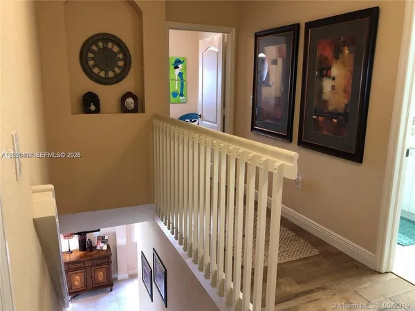 a view of a hallway with entryway and front door
