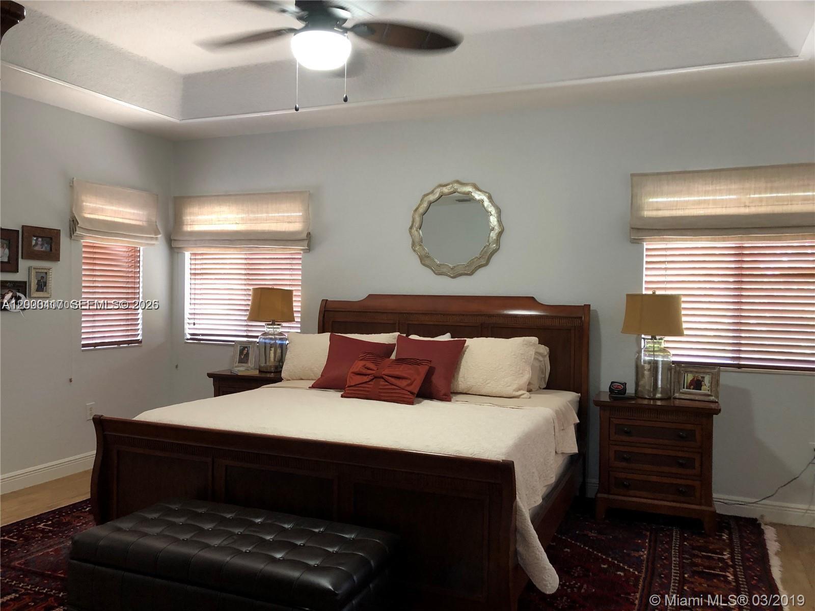 867 Southwest 155th Court, Unit 867 Miami, FL 33194 - Photo 12 of 25 a bed sitting in a bedroom next to a window
