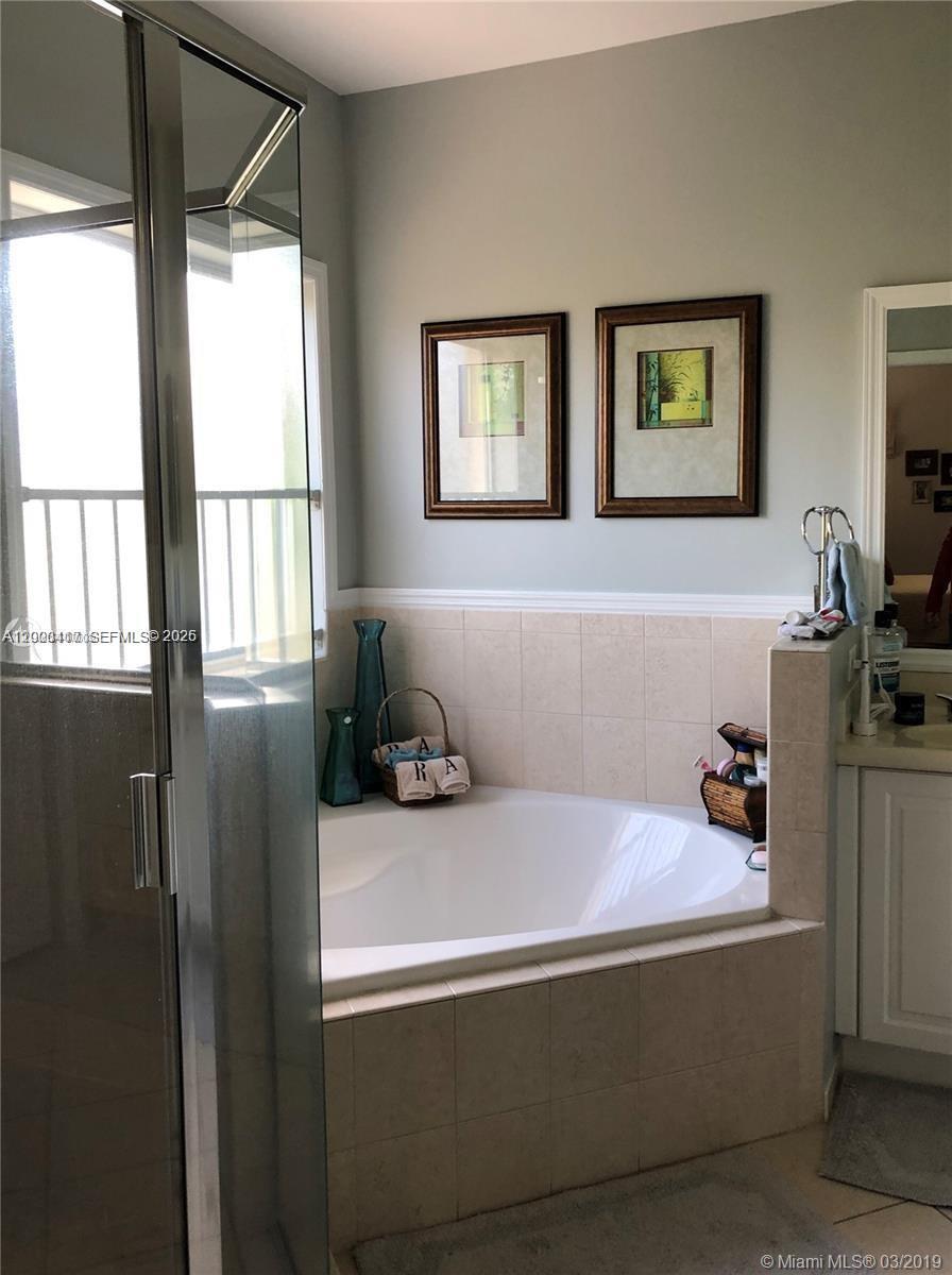867 Southwest 155th Court, Unit 867 Miami, FL 33194 - Photo 15 of 25 a bedroom with a bed and a window