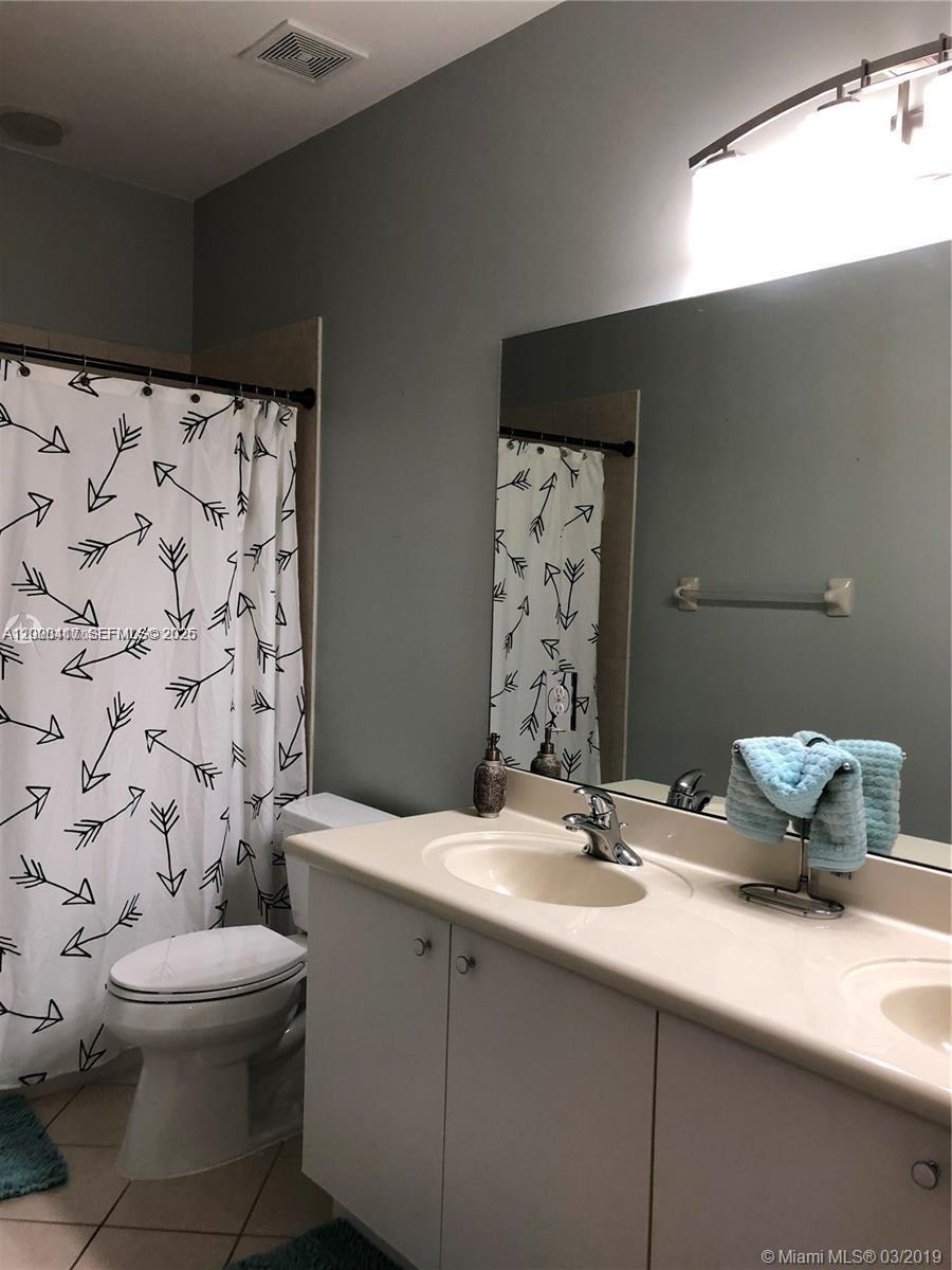 867 Southwest 155th Court, Unit 867 Miami, FL 33194 - Photo 17 of 25 a bathroom with a sink toilet and shower