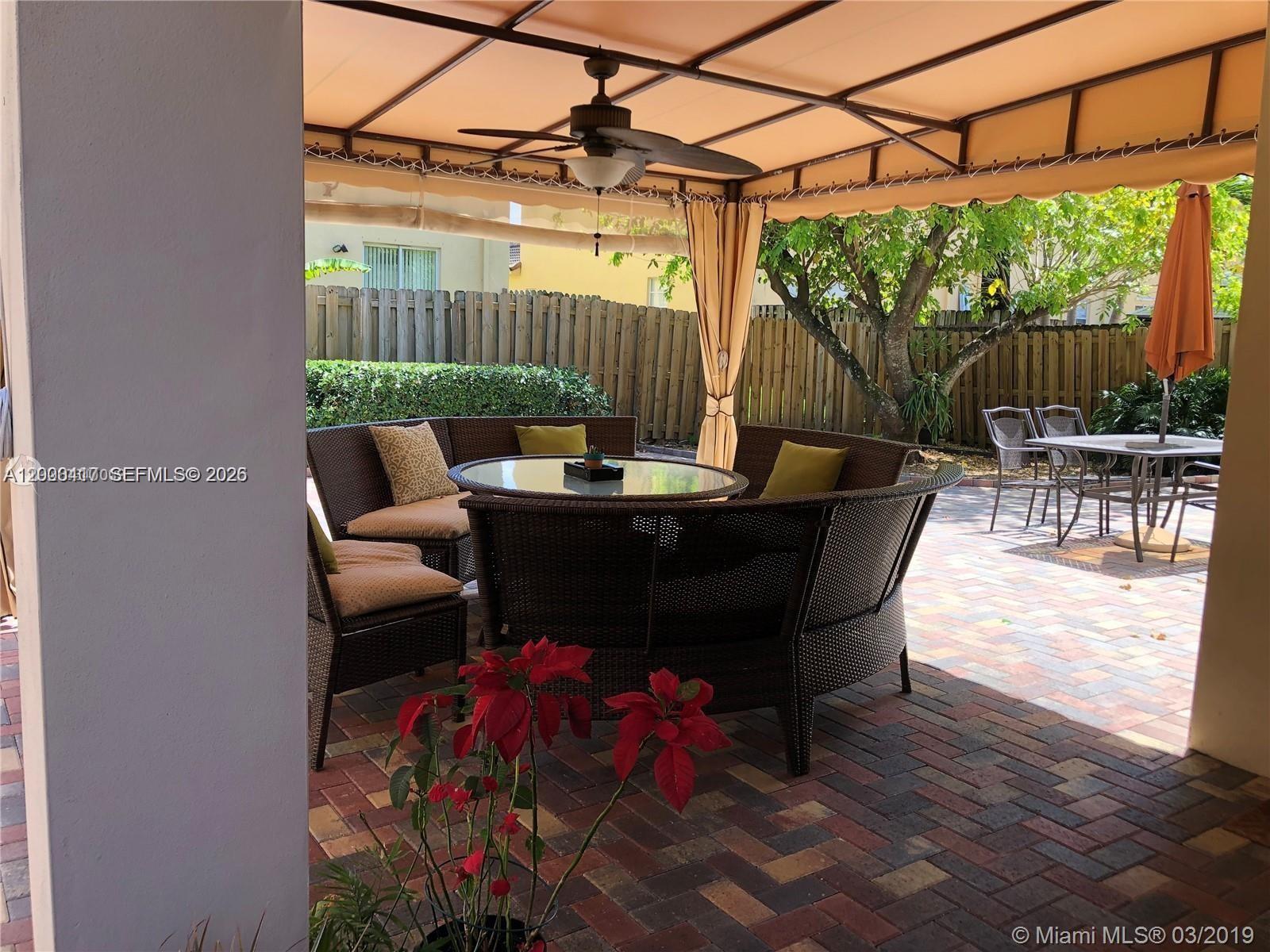 867 Southwest 155th Court, Unit 867 Miami, FL 33194 - Photo 20 of 25 a outdoor dining space with furniture and outdoor view